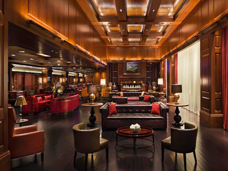 A beautiful lobby with a piano, tables and chairs