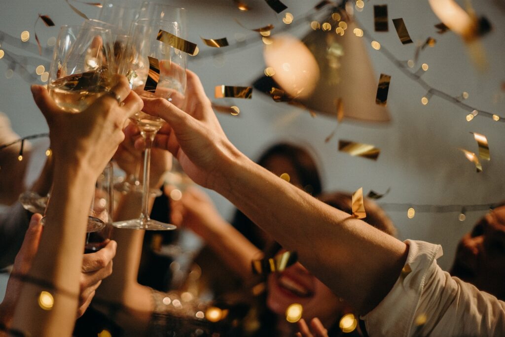 Image Source: https://www.pexels.com/photo/people-toasting-wine-glasses-3171837/ Image Text: People Toasting at an Event Alt-Text: Close-Up of Hands Toasting Wine Glasses at an Event Description: People Enjoying an Event in NYC