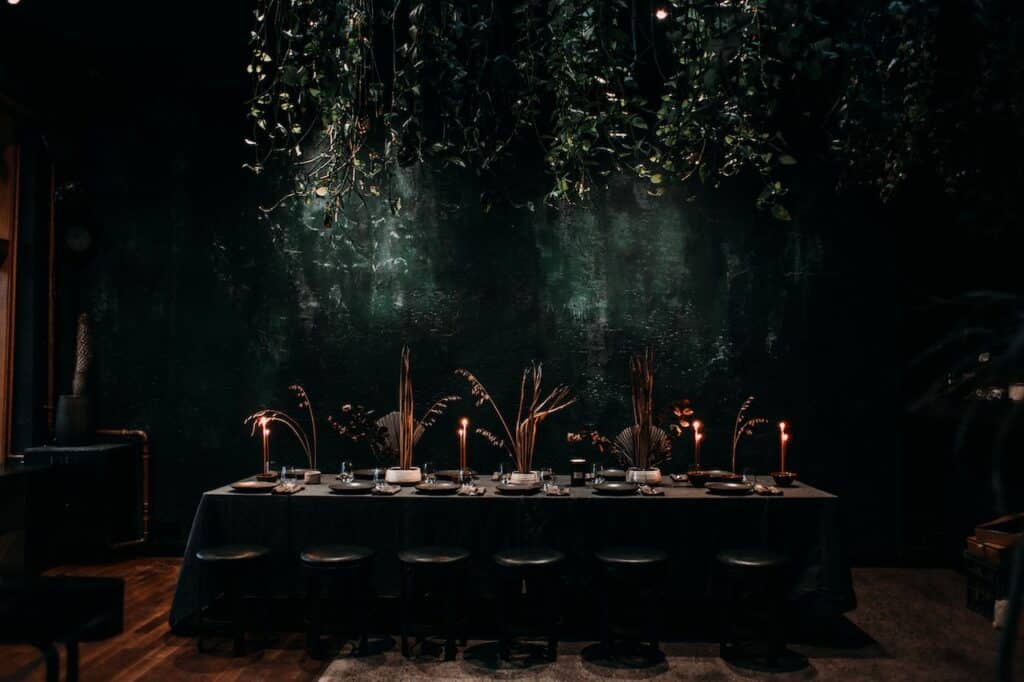 Photo by Rachel Claire: https://www.pexels.com/photo/row-of-stools-next-to-long-table-covered-with-tablecloth-in-dark-hall-4577179/ - holiday party