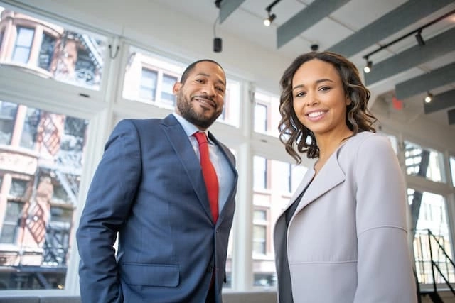 Photo by Rebrand Cities: https://www.pexels.com/photo/man-and-woman-smiling-inside-building-1367269/ -- corporate event