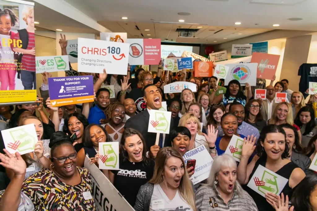 Charity Organizations in New York City Photo by GivingTuesday : https://www.pexels.com/photo/a-large-group-of-people-cheering-at-charity-event-9826015/