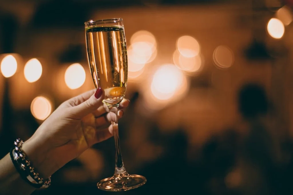 Photo by Maria Orlova: https://www.pexels.com/photo/unrecognizable-woman-with-glass-of-champagne-in-restaurant-4946720/ -- party
