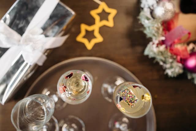 Photo by Pavel Danilyuk: https://www.pexels.com/photo/clear-drinking-glasses-on-brown-wooden-table-6405898/ -- office party