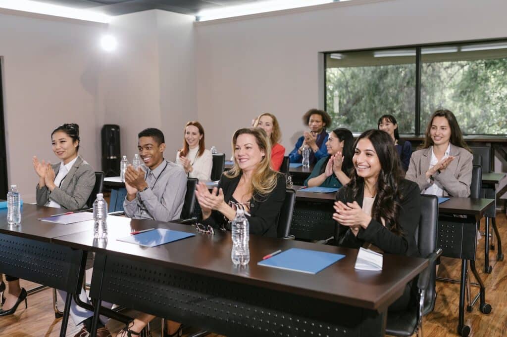 Photo by RDNE Stock project: https://www.pexels.com/photo/group-of-people-in-a-conference-room-clapping-7648476/ -- product launch