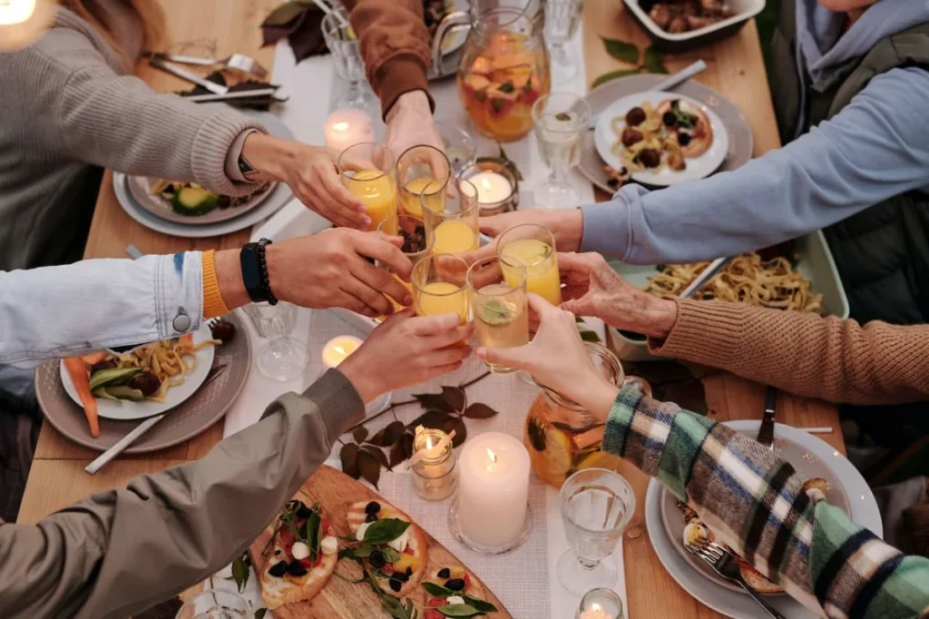 Photo by Askar Abayev: https://www.pexels.com/photo/faceless-people-toasting-with-glasses-at-dinner-5638748/ -- team-building dinner