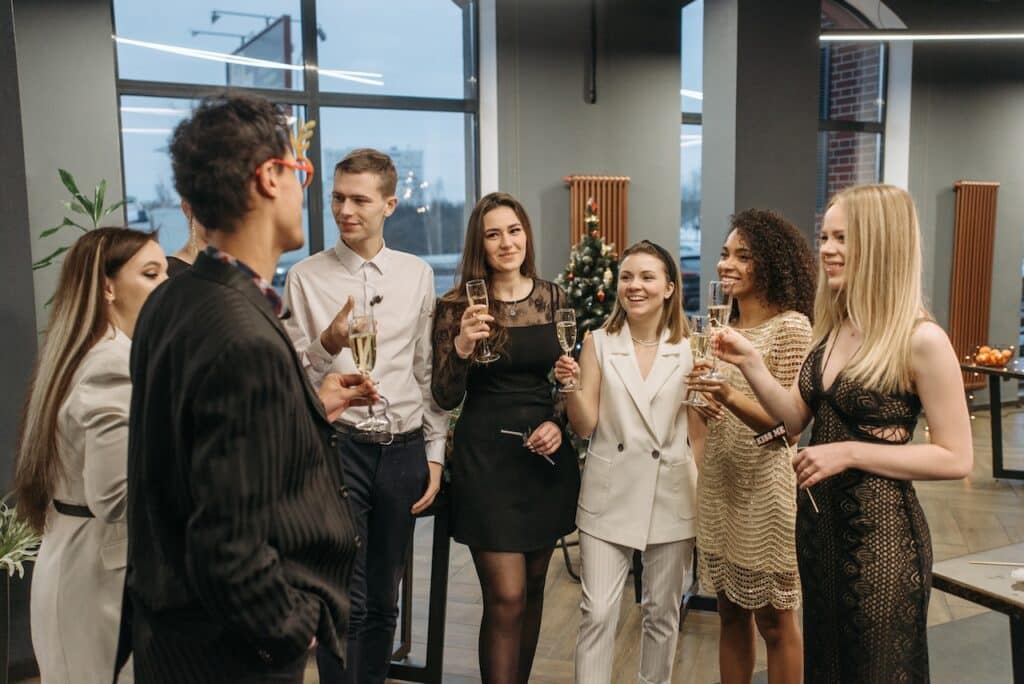 Photo by Pavel Danilyuk: https://www.pexels.com/photo/men-and-women-grouped-together-holding-wine-glasses-6405662/ -- office party