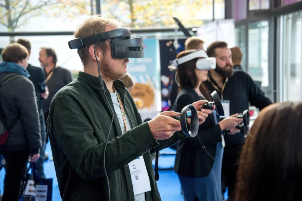 Image Text: Tech tools can enhance an event’s experience Alt-Text: Digital age event planning Image Description: A person wearing VR smartphone headsets in a room Image Source: https://unsplash.com/photos/NN9HQkDgguc
