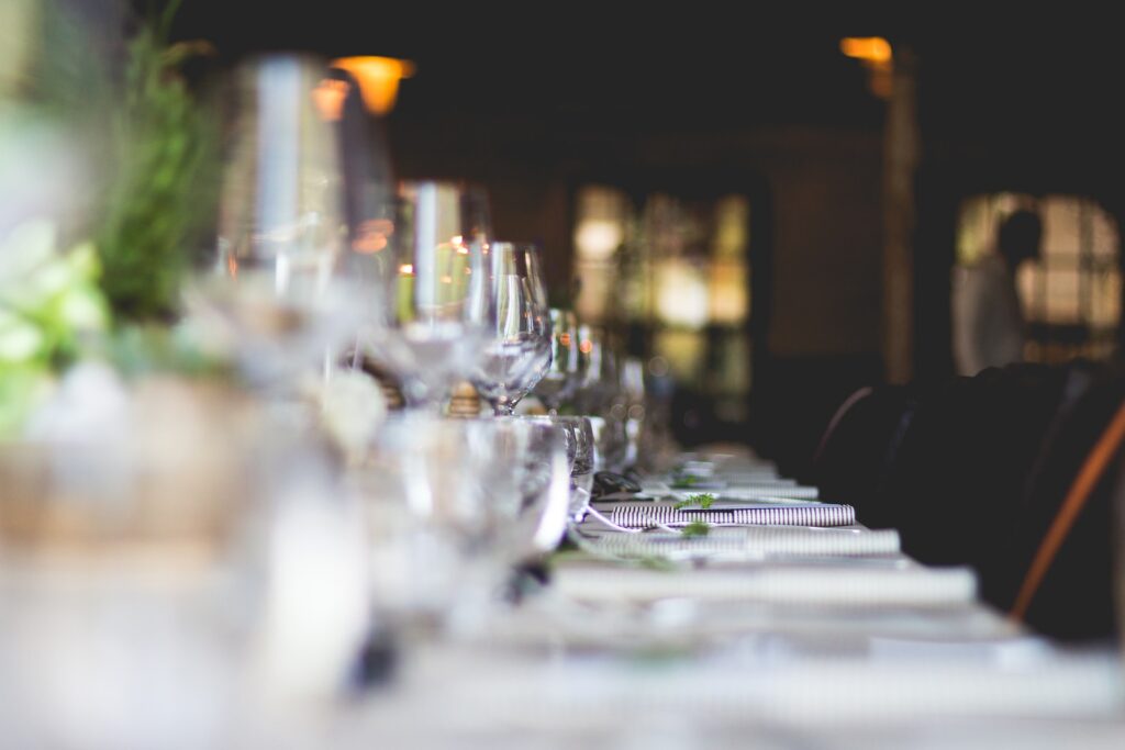 Image Title: Corporate event Decor and Ambiance Image Description: Close-up of a meticulously arranged dining table with glassware and décor Alt Text: A detailed view of a table setting emphasizing event ambiance Source: https://unsplash.com/photos/BCkLxilDvJU