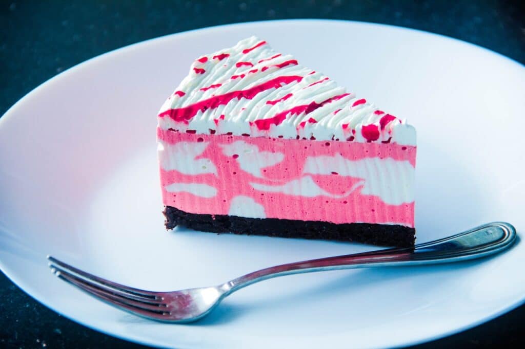Photo by ERIC MUFASA: https://www.pexels.com/photo/sliced-white-and-pink-icing-covered-cake-on-white-plate-with-silver-colored-fork-1414234/ -- birthday cake