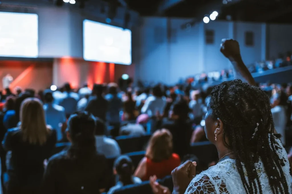Image Title: Engaged Audience at Event Image Description: Attendees watching a presentation at a conference Alt Text: Crowd of people at a conference focused on a presentation stage Source: https://www.pexels.com/photo/photo-of-people-gathering-in-room-2833037/