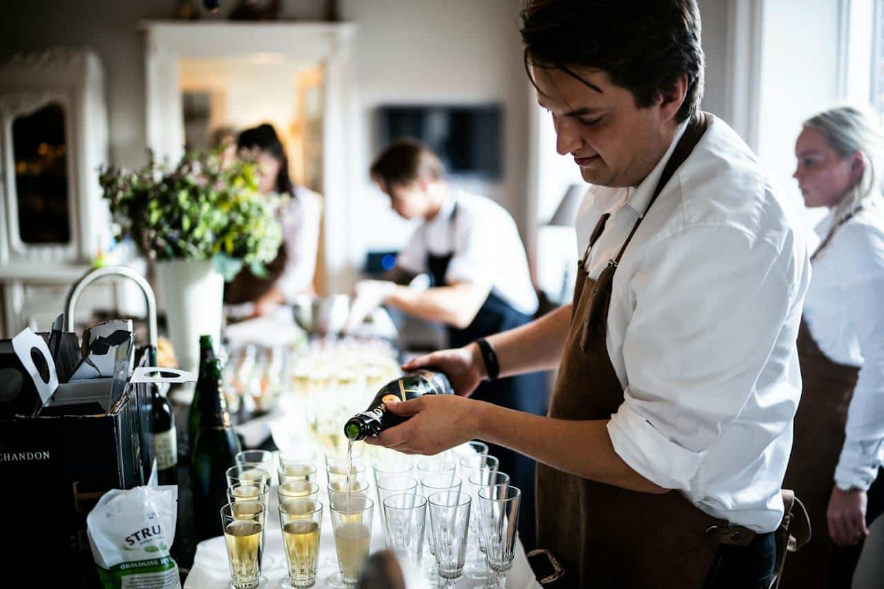 Photo by Rene Asmussen: https://www.pexels.com/photo/man-pouring-wine-on-glasses-3217157/ - catering