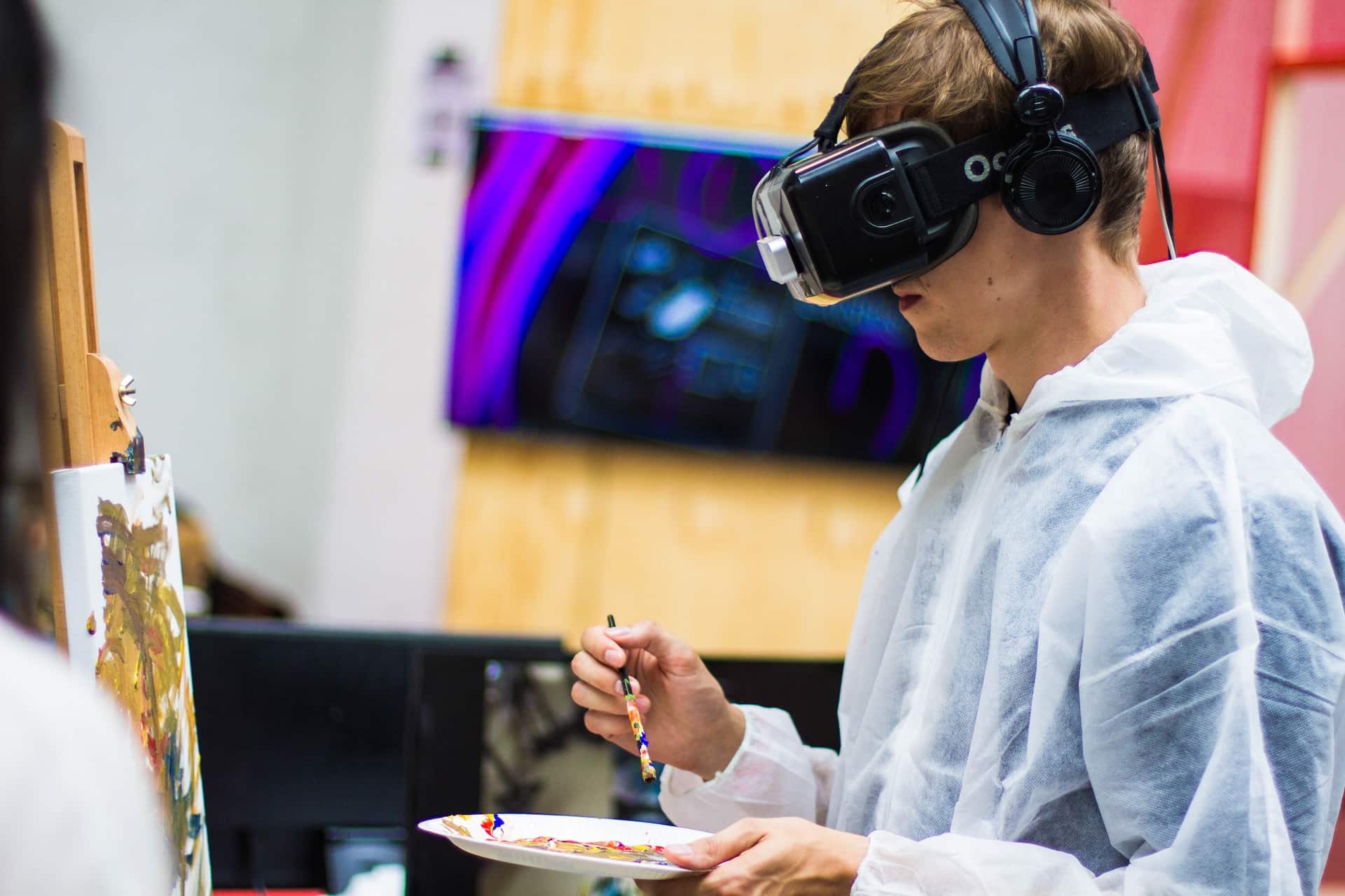 Image Title: VR in Creative Innovation Image Description: An artist immersed in a virtual reality environment at a product launch Alt Text: VR painting innovation Source: https://unsplash.com/photos/man-wearing-black-virtual-reality-headset-while-painting-near-brown-wall-3eAByt3-eOw