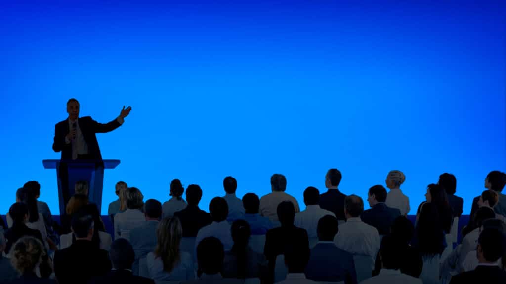 Image Title: Product Launch Presentation Image Description: Presenter at product launch event showcasing a large screen to an audience Alt Text: Product launch auditorium Source: Image by rawpixel.com on Freepik