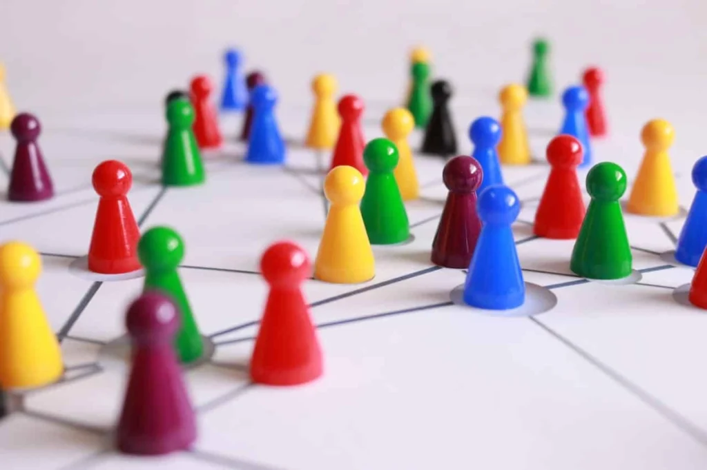 Photo by Pixabay from Pexels: https://www.pexels.com/photo/close-up-photography-of-yellow-green-red-and-brown-plastic-cones-on-white-lined-surface-163064/ -- team on a board