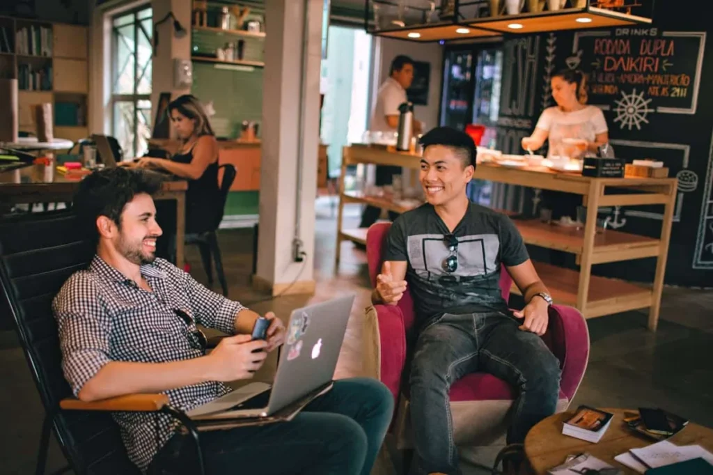 Photo by Helena Lopes: https://www.pexels.com/photo/photograph-of-men-having-conversation-seating-on-chair-1015568/ -- office party