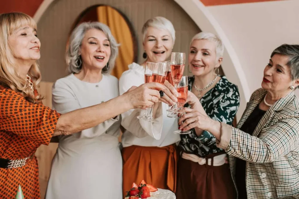 Photo by Vlada Karpovich: https://www.pexels.com/photo/a-group-of-elderly-women-clinking-glasses-7561105/ -- milestone birthday party