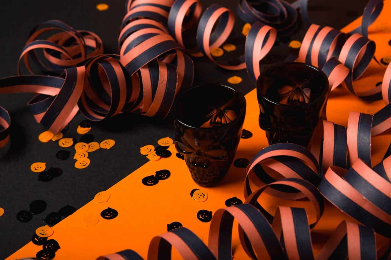 Photo by Toni Cuenca: https://www.pexels.com/photo/two-black-glass-cups-619423/ -- company halloween party