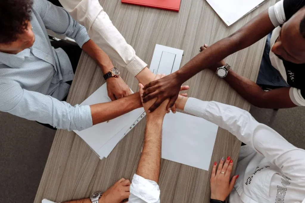 Photo by Thirdman: https://www.pexels.com/photo/man-and-woman-holding-each-other-s-hands-as-a-team-5256816/ -- company culture