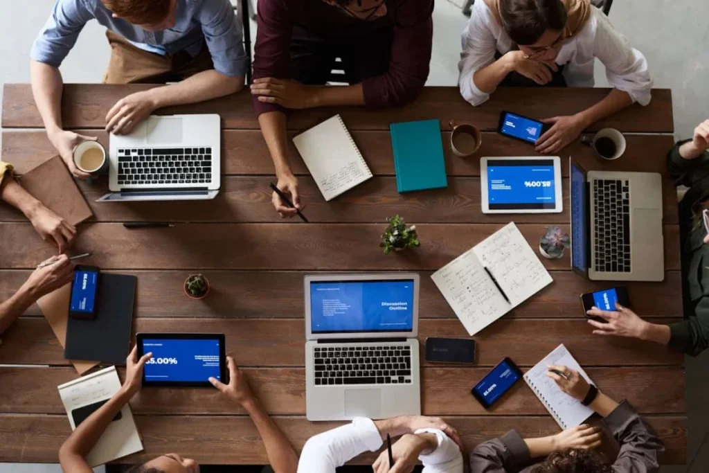 https://www.pexels.com/photo/top-view-photo-of-people-near-wooden-table-3183150/ corporate event meeting