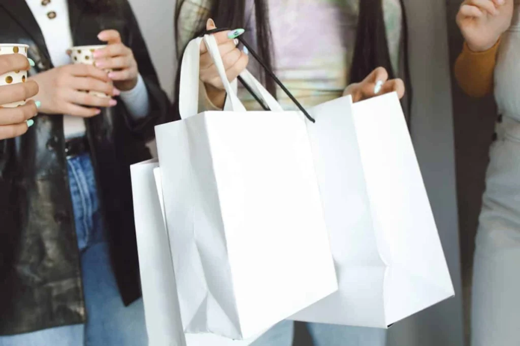 Photo by Polina Tankilevitch: https://www.pexels.com/photo/woman-holding-paper-shopping-bags-7337023/ -- corporate event