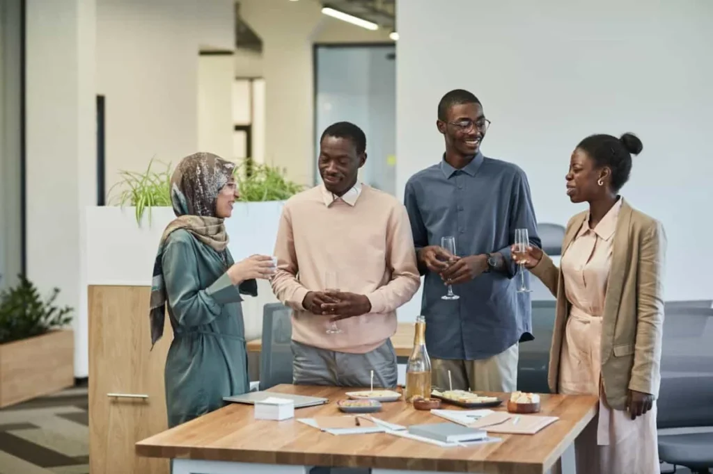 Photo by Edmond Dantès: https://www.pexels.com/photo/a-people-holding-a-drink-while-talking-together-8555432/ -- company office parties