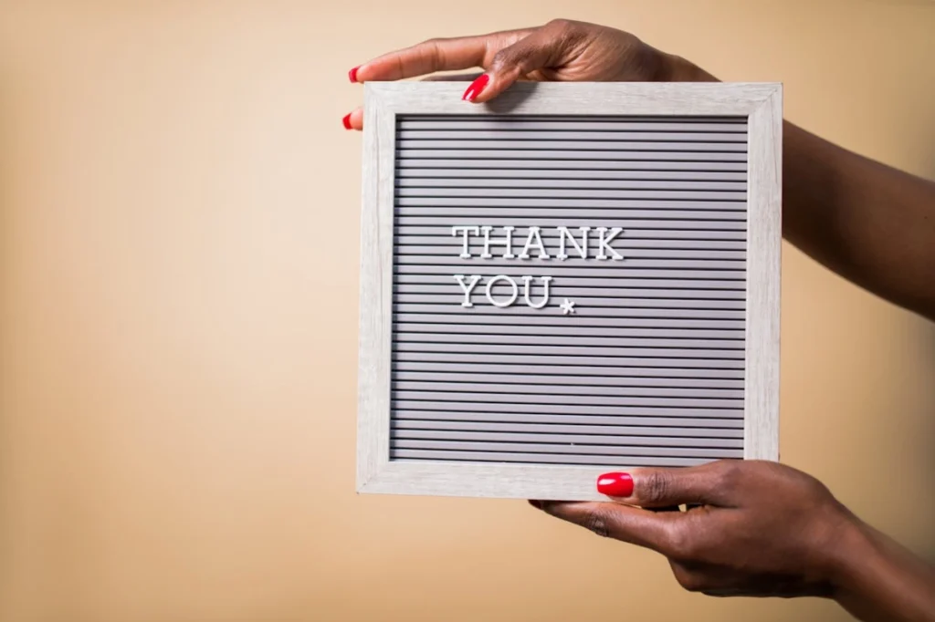 Photo by RDNE Stock project: https://www.pexels.com/photo/a-person-holding-a-gray-thank-you-signage-7563672/ -- client appreciation thank you