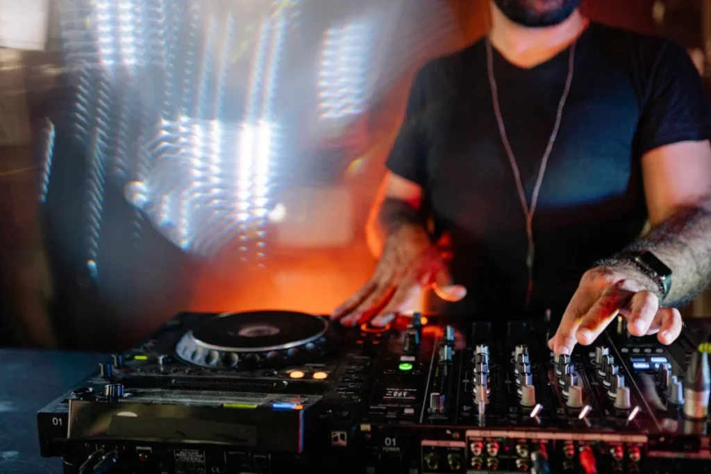 Photo by Yan Krukau: https://www.pexels.com/photo/man-in-black-t-shirt-playing-dj-mixer-9005449/ -- DJ, mitzvah planning
