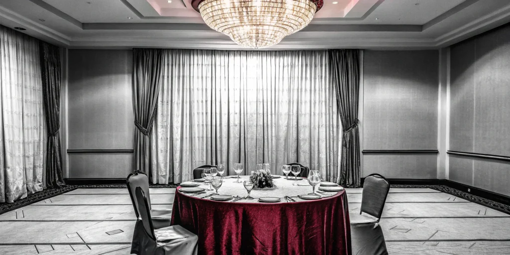 An elegant table setting with a chandelier, planned for a black tie gala.