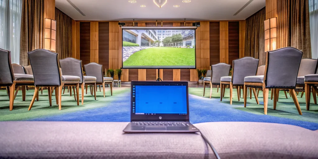 A conference room setup for a hybrid event, planned to accommodate both in-person and virtual guests.