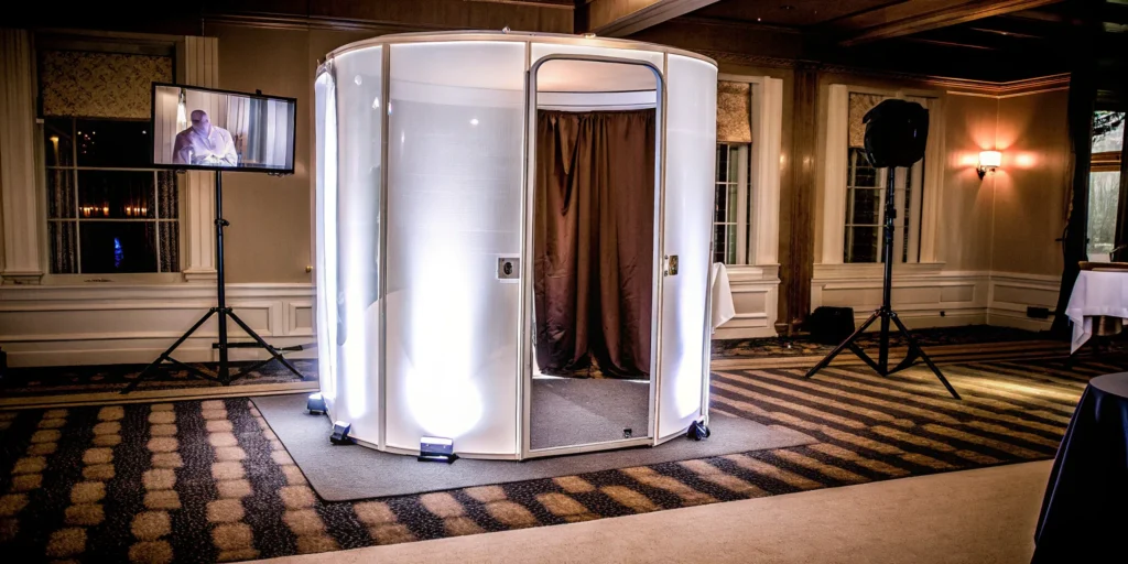 A 360 photo booth with a rotating camera arm and bright LED lights ready for an event.