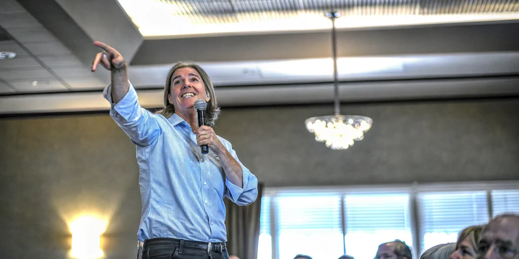 A keynote speaker on stage engaging the audience during a presentation.