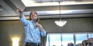 A keynote speaker on stage engaging the audience during a presentation.