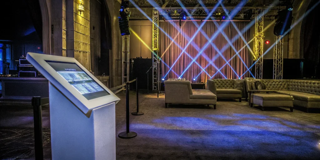 A modern brand activation event featuring an interactive kiosk and lounge area.