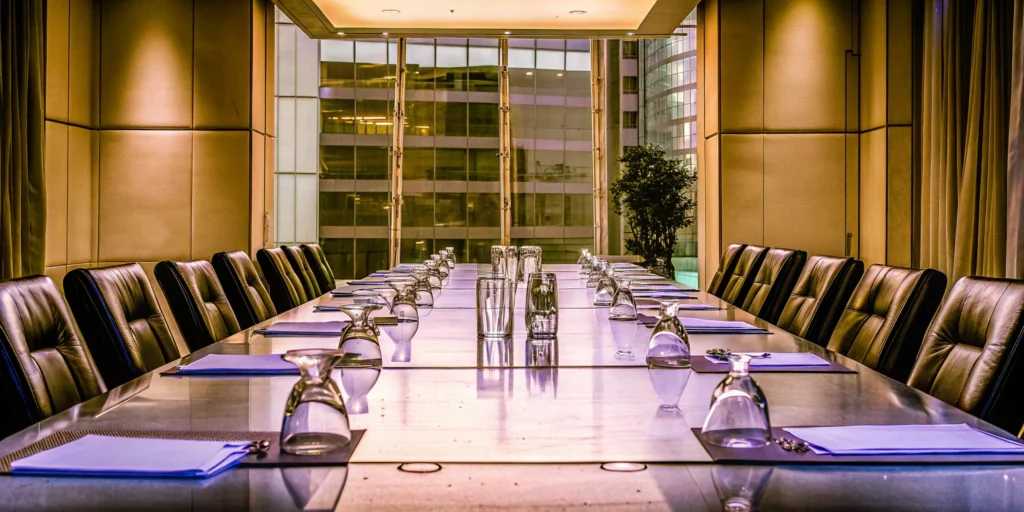 A modern boardroom set for a corporate event, the result of successful planning.