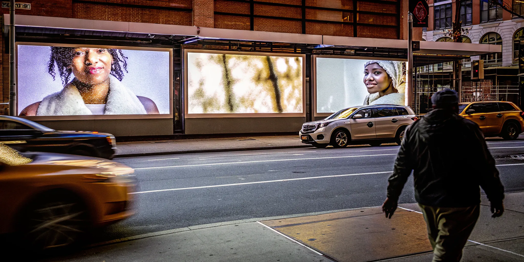 An experiential marketing agency campaign on digital billboards in a busy city at night.