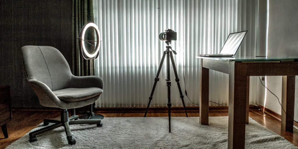 Essential gear for a home live streaming setup, including a camera, light, and laptop.