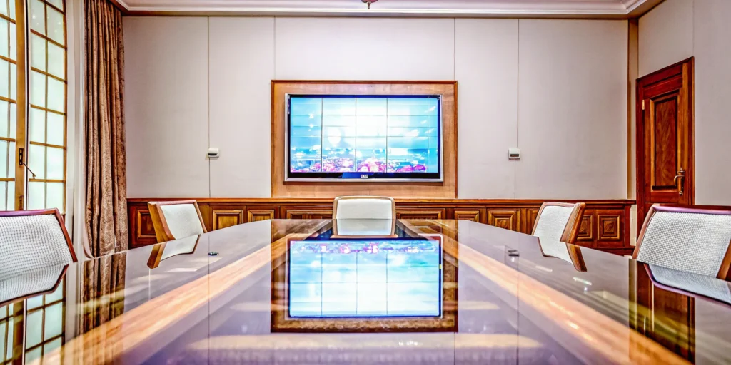 A conference room showing why hybrid events work, connecting in-person and remote attendees.