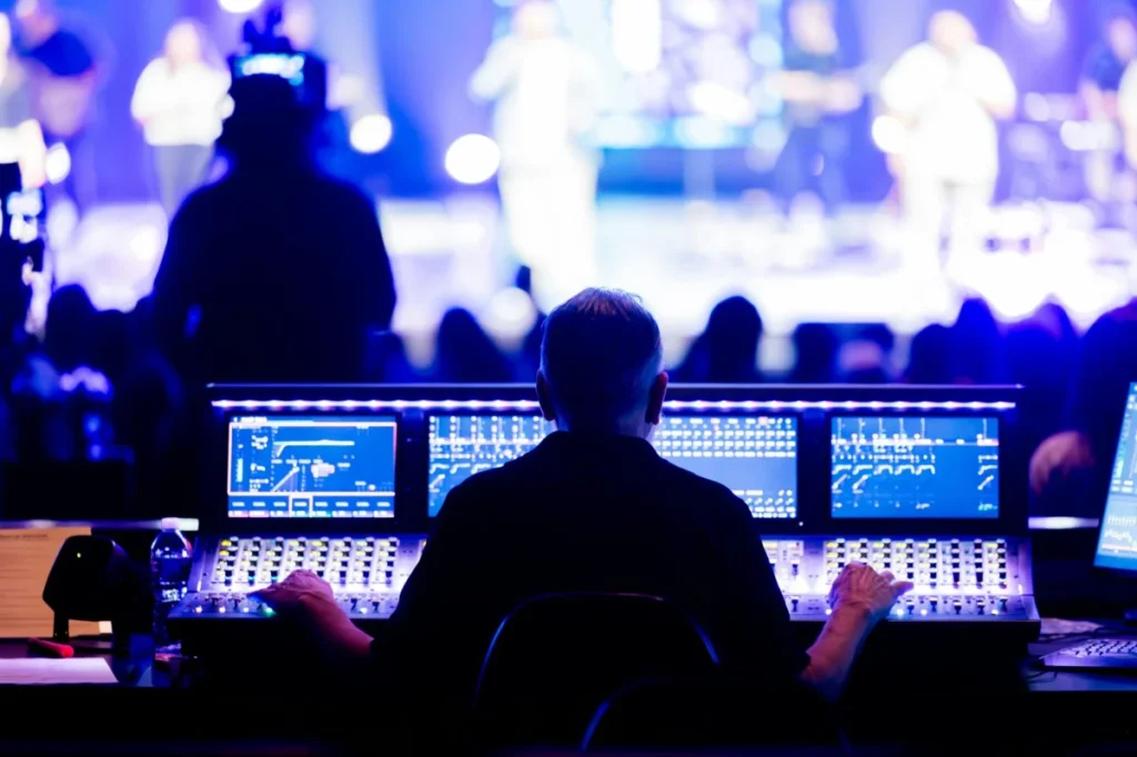 Photo by Caleb Oquendo: https://www.pexels.com/photo/sound-engineer-at-concert-soundboard-setup-34612567/