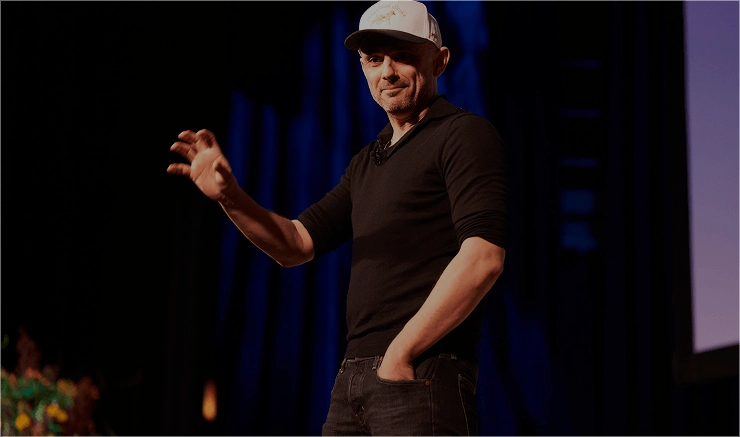 Speaker presenting on stage during a corporate event organized by EMRG Media in New York City.