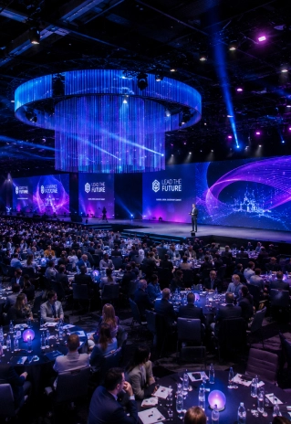 Large corporate event with keynote stage, lighting, and attendees at a professionally planned event by EMRG Media in NYC.