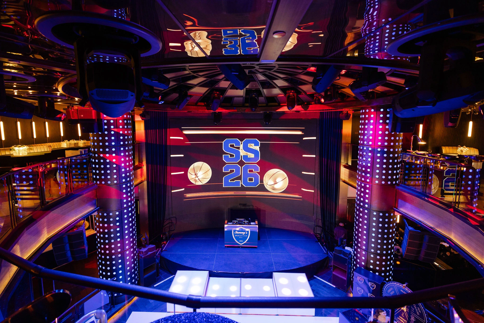 "SS 26" branded stage with LED pillars and multi-level seating at a NYC event, EMRG Media