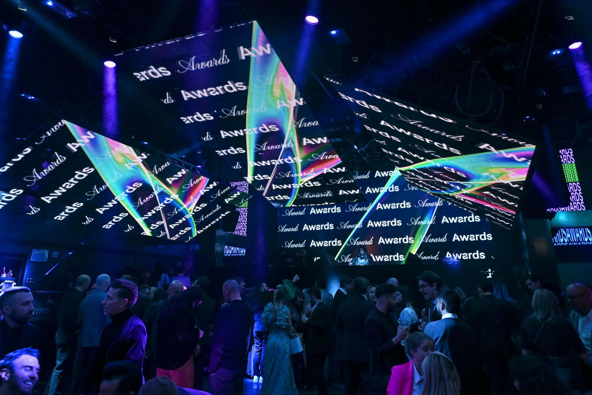 Repeating "Awards" text projection over a crowd at an AV production event, EMRG Media