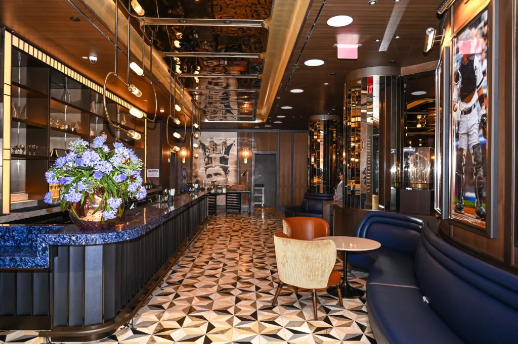 Upscale NYC lounge interior with mosaic floor and gold-trimmed bar, event venue photography by EMRG Media