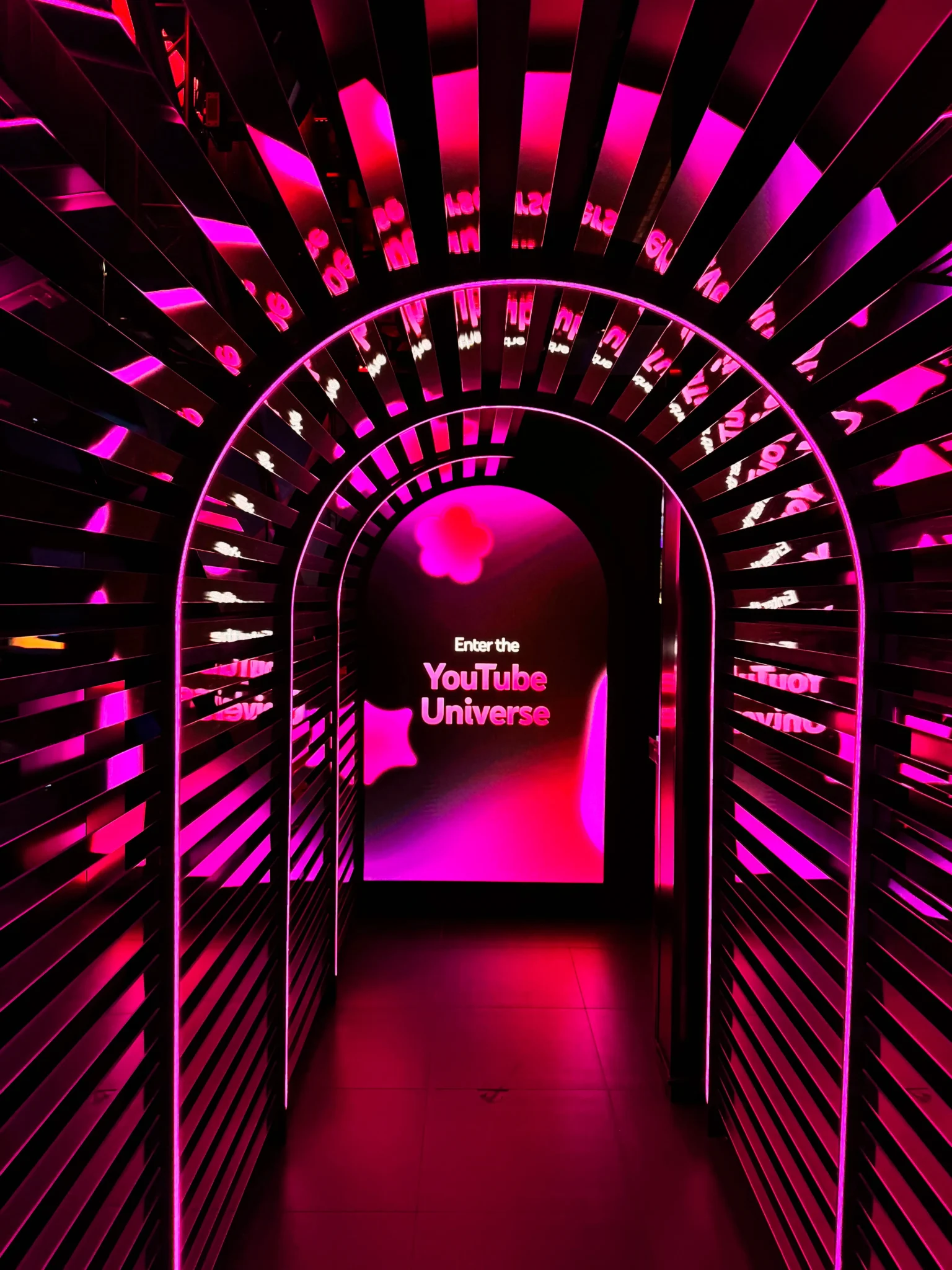 "Enter the YouTube Universe" tunnel entrance lit in pink at a NYC branded event, EMRG Media