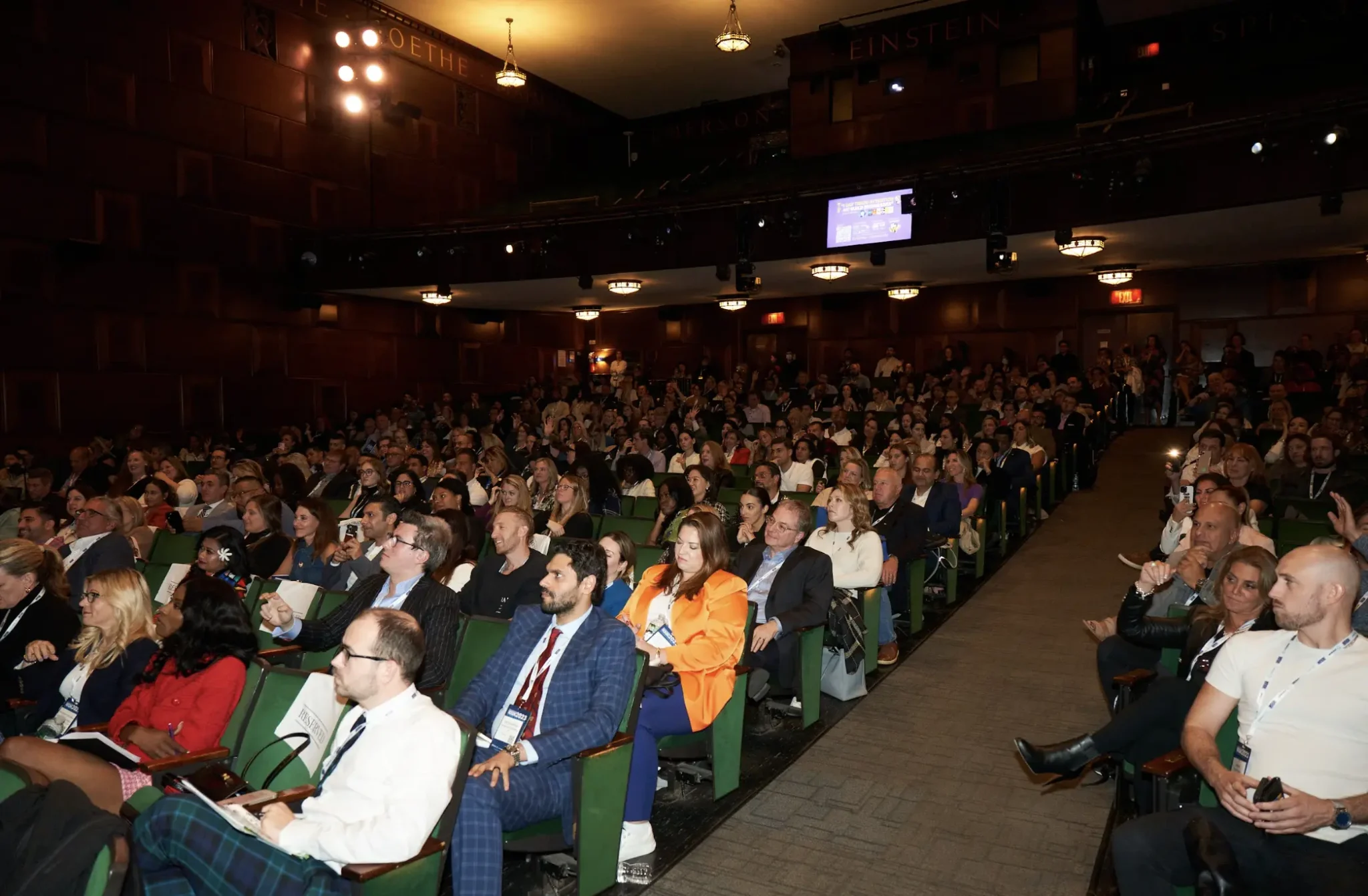 Full theater audience seated at a large-scale NYC conference, photographed by EMRG Media