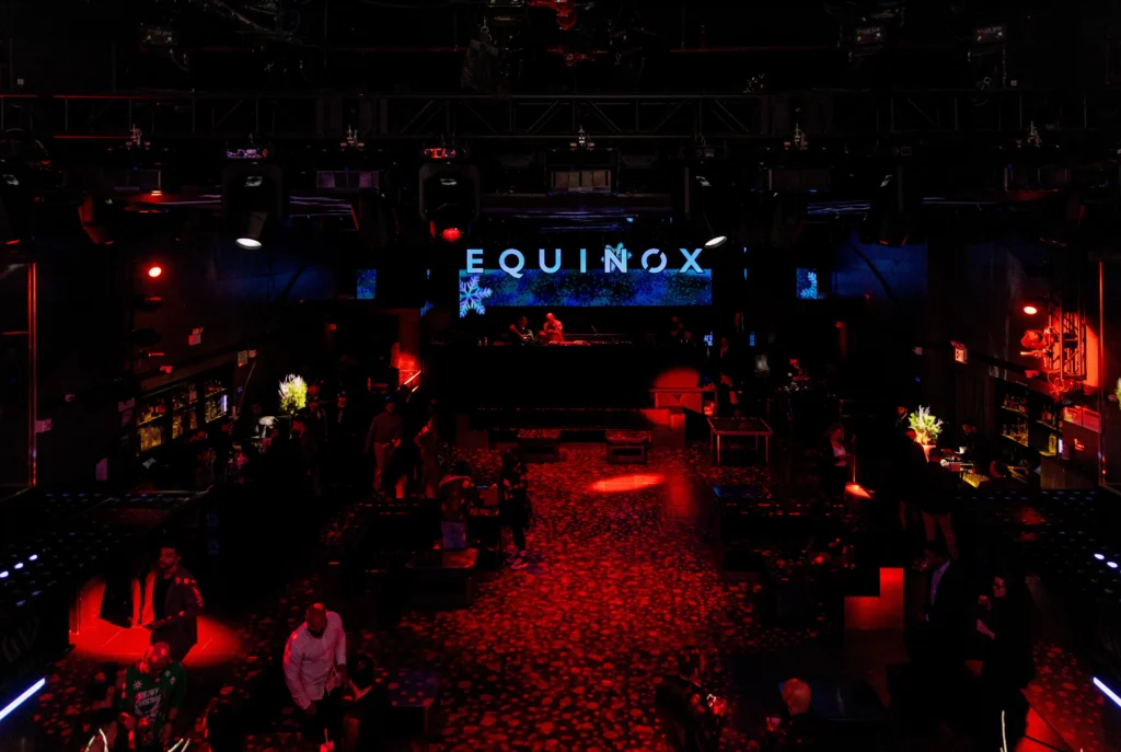 Equinox branded stage bathed in red spotlight at a NYC event venue, EMRG Media