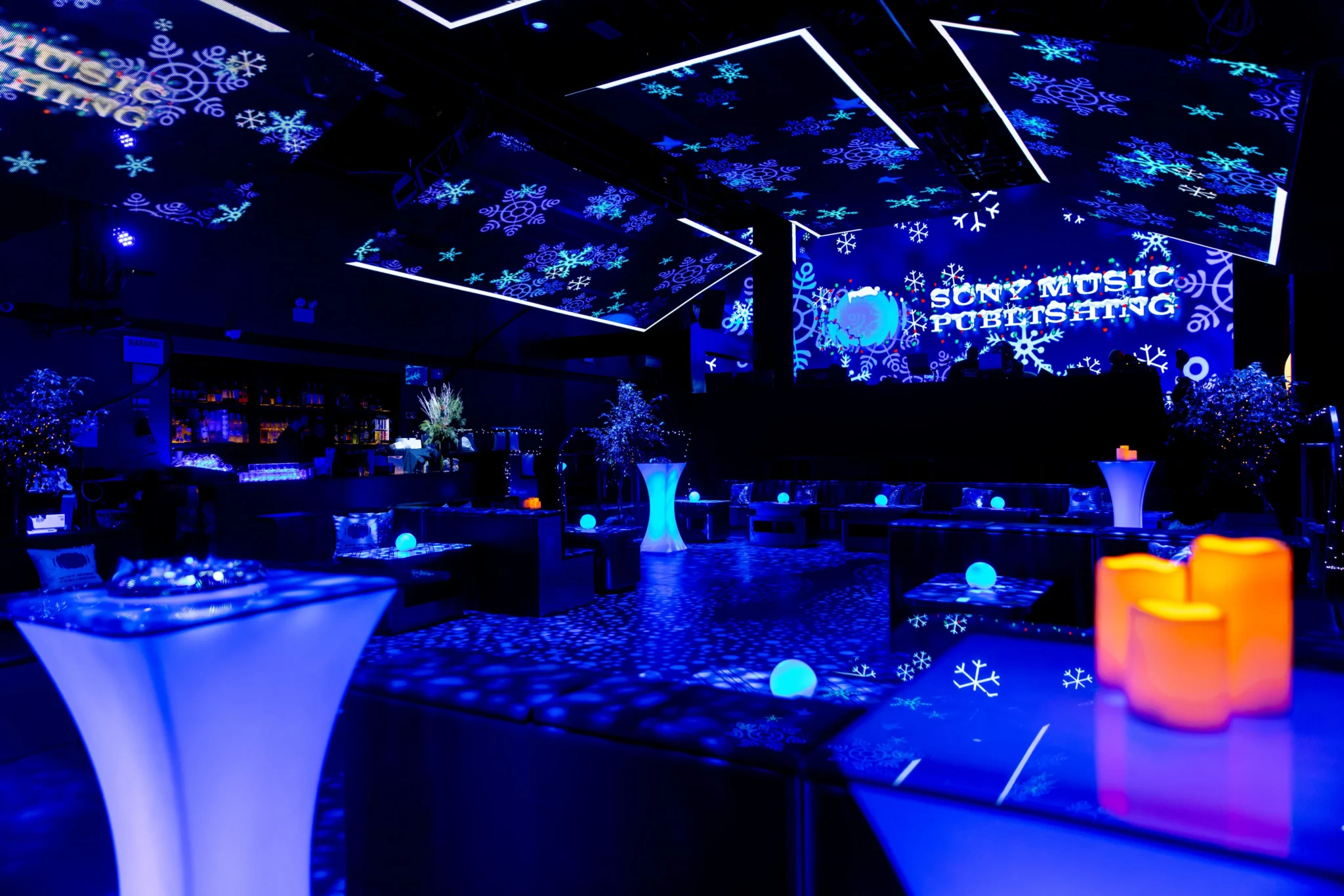 Sony Music Publishing winter-themed lounge with blue snowflake projections at a NYC holiday event, EMRG Media